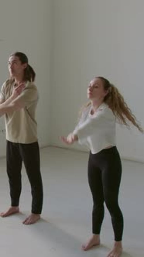 Young Dancers Performing Arm Circles during Warm Up in Studio
