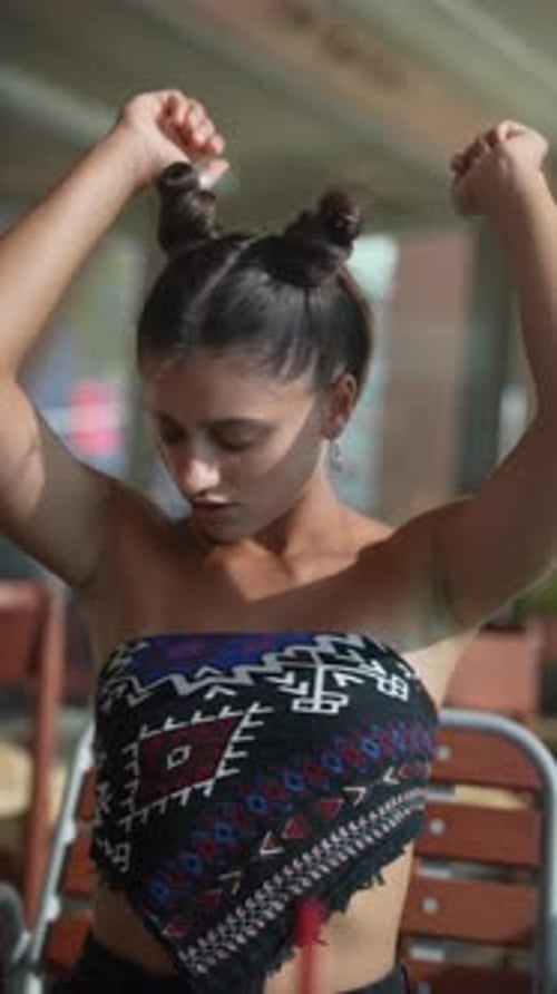 Young Woman Smiles and Poses in the Sun