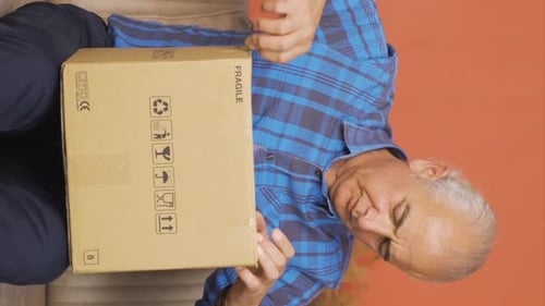 Senior Man Receiving Delivery in Cardboard Box