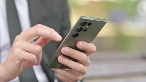 Close up of Businessman using Smartphone Outdoor