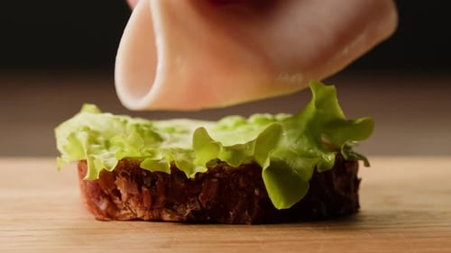 Making a Ham Sandwich with Bread and Lettuce