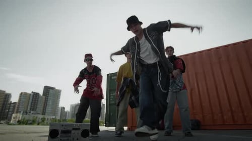 Skilled Zoomer Performing Breakdance Outdoors in front of Peers