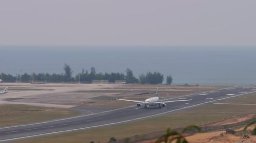 Airplane on Runway at Tropical Airport