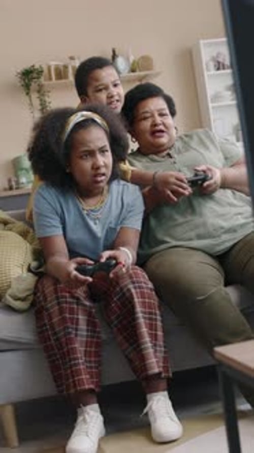 Family Playing Video Games on Couch at Home