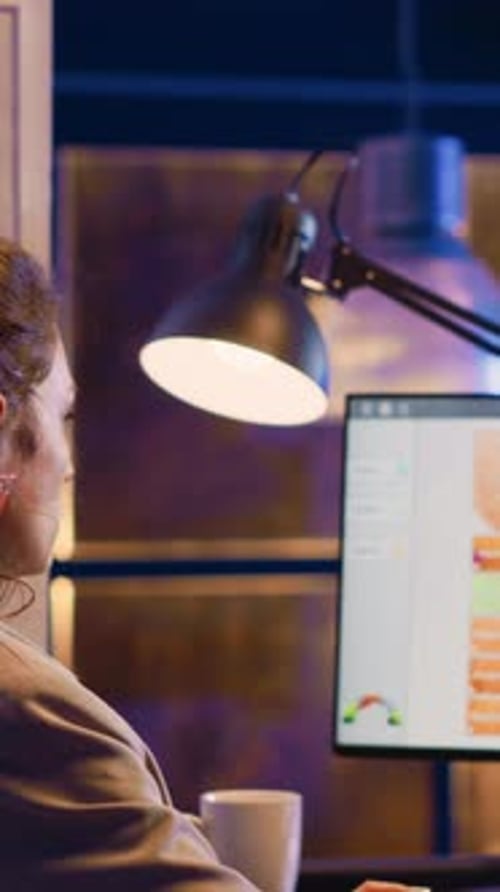 Vertical Video Office Worker Looking at Computer Running Diagrams