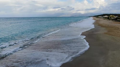Aerial view of Ocean waves crashing on sandy beach in Agios georgios pagon,Corfu ,Greece