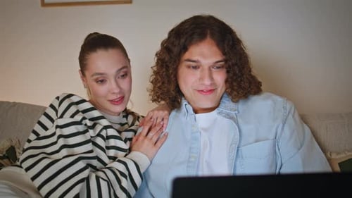 Young Couple Relaxing at Home with Computer