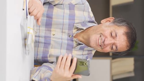 Man Counting Stacks of Cash With His Phone