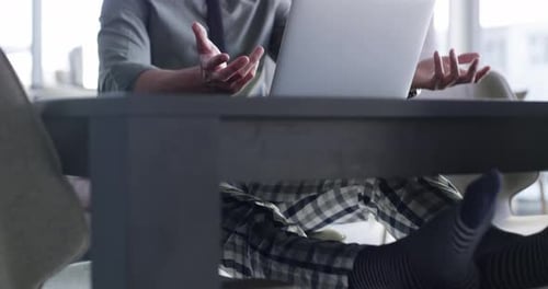 Young Adult Man Talking on Laptop at Home