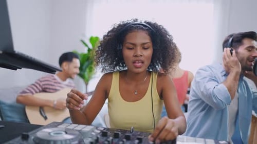 Diverse young stylish audio producer working in the music record studio.