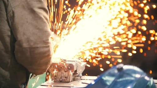 Industrial Concept A Man Worker Cut a Black Chain with