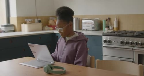 Young Adult Working on Laptop at Home