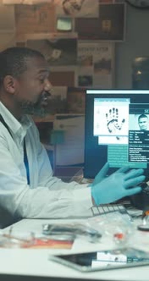 Man Working at Computer in Police Investigation Room