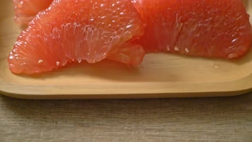 Fresh Pink Grapefruit Segments on Wood Tray