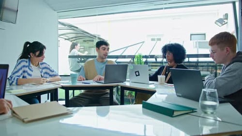 Coworkers Discussing Business Plan on Paper in Modern Office