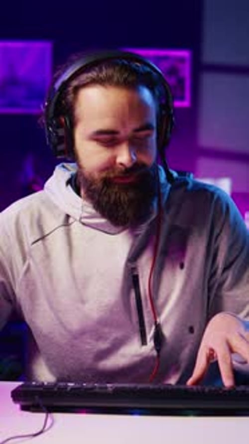 Young Adult Man Playing Video Games at Night