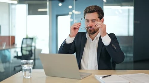 Professional Businessman Works on Laptop Smiling