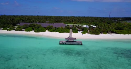 Close up aerial drift of Maldives dock on secluded island. White sand and turquoise water vanishing