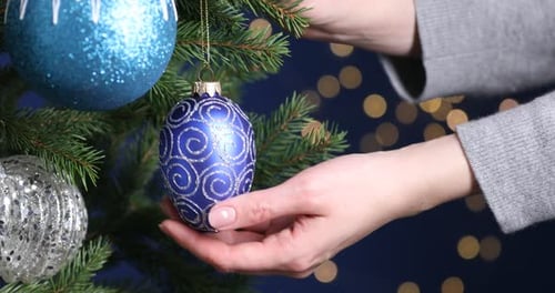 Decorating a Christmas Tree with Elegant Blue Ornaments