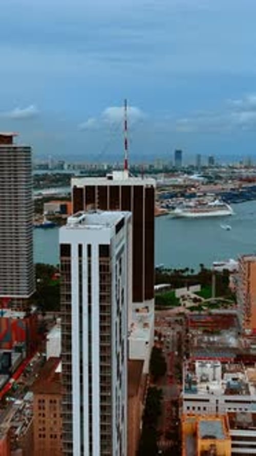 Drone footage among the high-rise buildings and approaching the waterscape. View on Miami, Florida