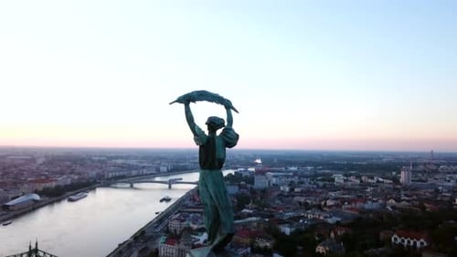Budapest liberty statue and view of the early sun over the city