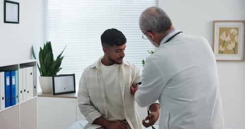 Blood pressure, check up and doctor with man in clinic for medical exam, support and consulting