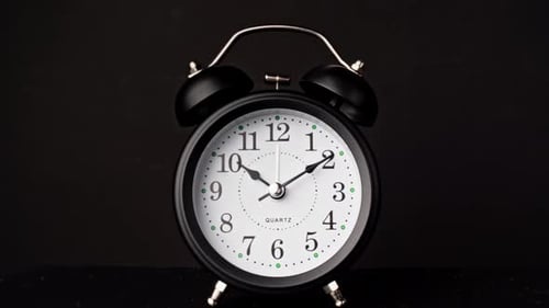 Alarm Clock Ticking Timelapse Zooming in on Clockface