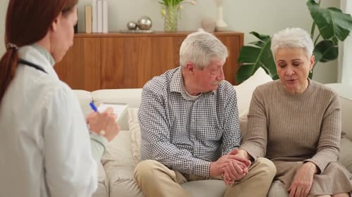 Female Doctor Examining Older Senior Couple in Doctor Office or at Home Old Woman Man Patient and