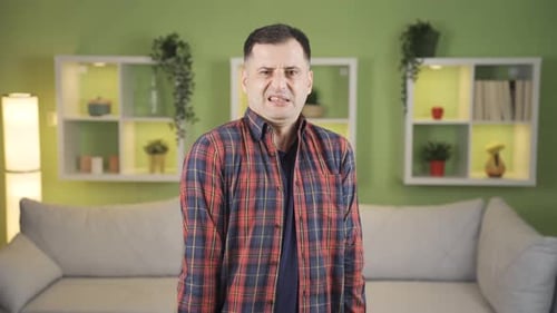 The man was looking at the camera with disgust.