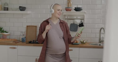 Pregnant Woman Dancing in Modern Kitchen