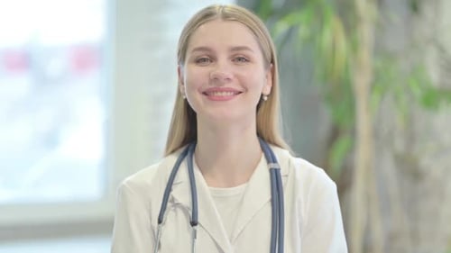 Smiling Young Adult Woman Doctor in White Coat