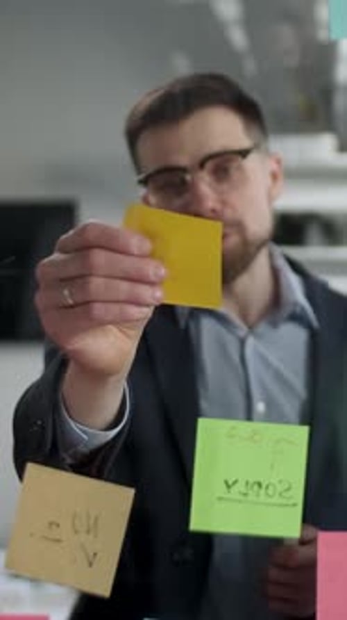 Business Man Explaining Ideas Using Sticky Notes