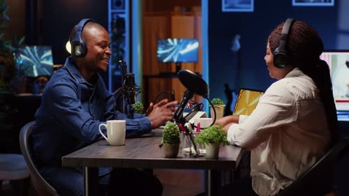 Influencer Recording Podcast with Guest Using Professional Equipment in Home Studio