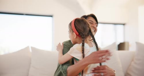 Loving Embrace: Child Hugs Adult in Bright Home