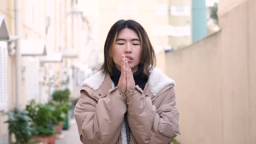 Young Adult Coughing and Blowing Nose on City Street