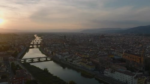 Aerial Ascending Footage of Historic City Centre with Famous Landmarks and Arno River Flowing Around