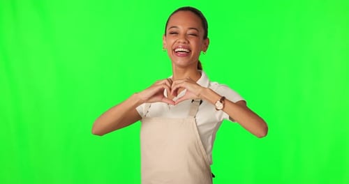 Green screen face, heart hands and happy woman, barista or smile for hospitality service