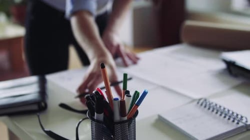 Businesswoman working remotely in modern home office with digital blueprints