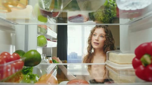Woman Opens Fridge, Takes Fresh Green Apple