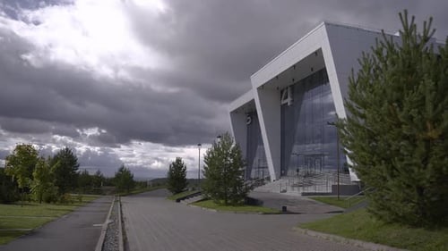 Futuristic Buildings with Numbers on Facades Under Clouds
