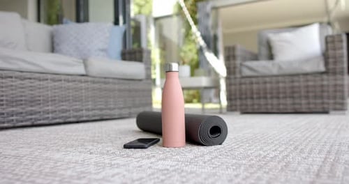 Yoga Mat, Water Bottle, and Phone on Patio
