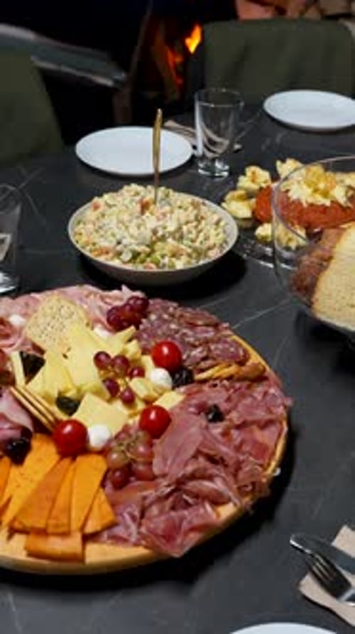 Christmas dinner table with cheese platter cold cuts and salad festive home gathering