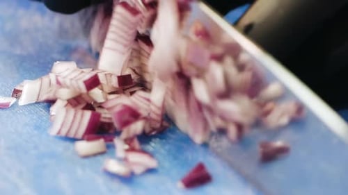 Dicing Red Onion with Knife on Cutting Board