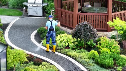 Man Pressure Washing Garden Bricks Made Path Using Modern Pressure Washer