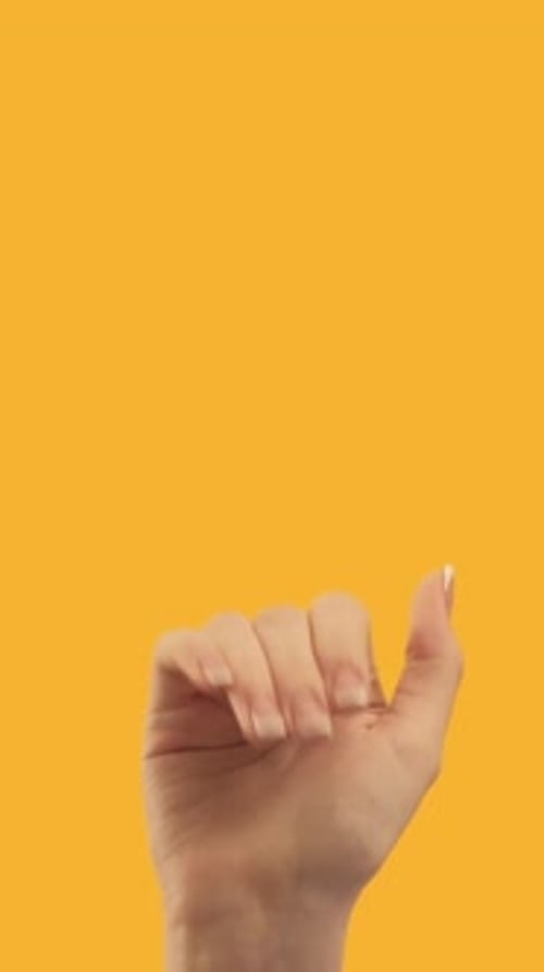 Hand Making Pinky Promise Gesture on Yellow Background