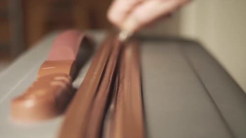Hand zipping grey suitcase closed, Close Up Selective Focus