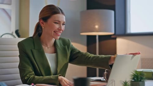 Happy Young Woman Using Laptop in Modern Office