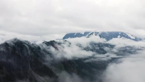Stunning rugged cloudy forested alpine landscape of Mt Baker in Northern Cascades region of PNW
