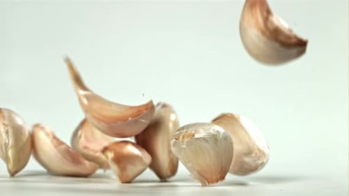 Fresh Garlic Falls on the Table Filmed on a Highspeed Camera at 1000 Fps