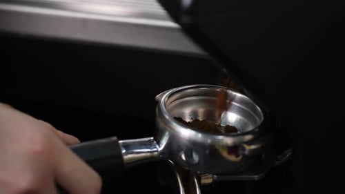 Ground Coffee Poured Into Tamper Metal Cup in Cafe Closeup